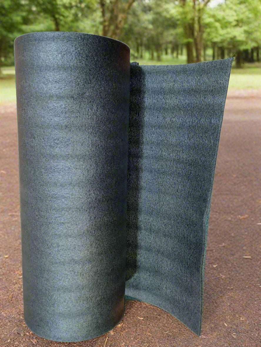 Roll of black carpet on a wooden floor