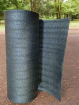 Roll of black carpet on a wooden floor